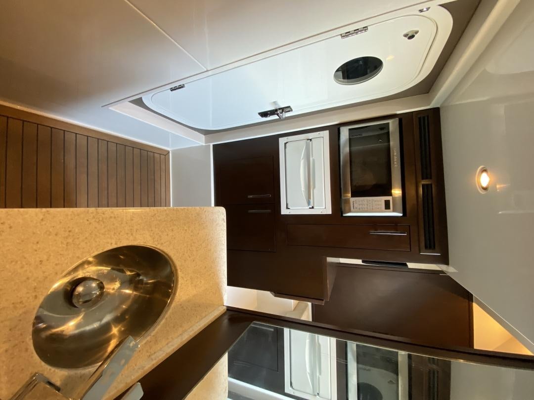 a kitchen with a sink and a microwave aboard No Name Yacht for Sale