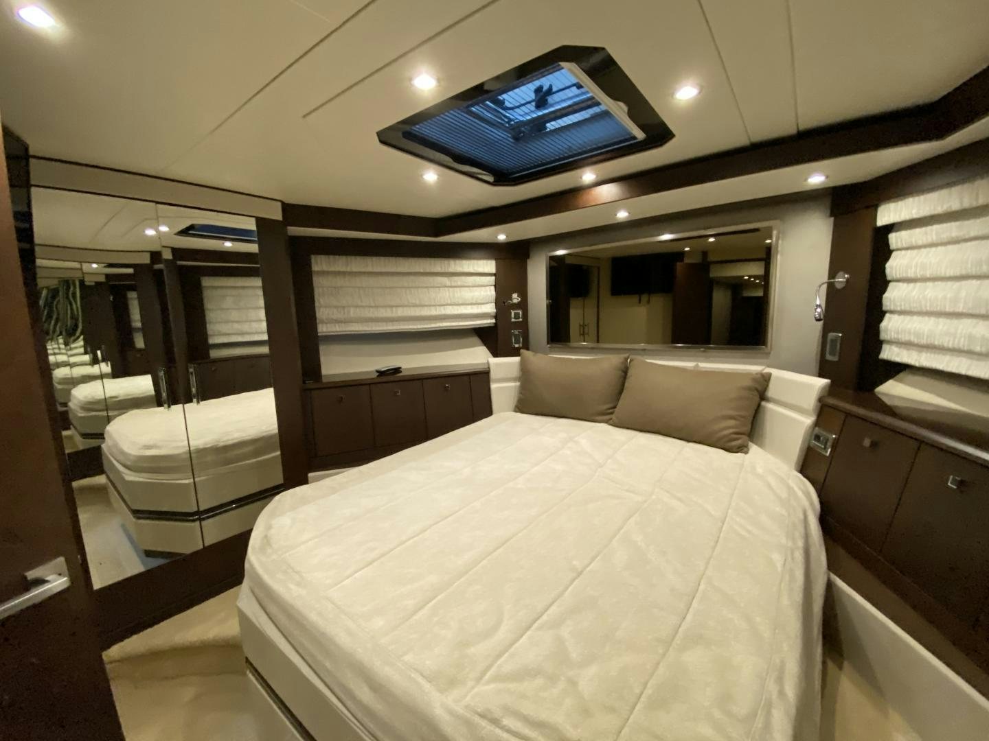 a room with a bed and a tv on the wall aboard No Name Yacht for Sale