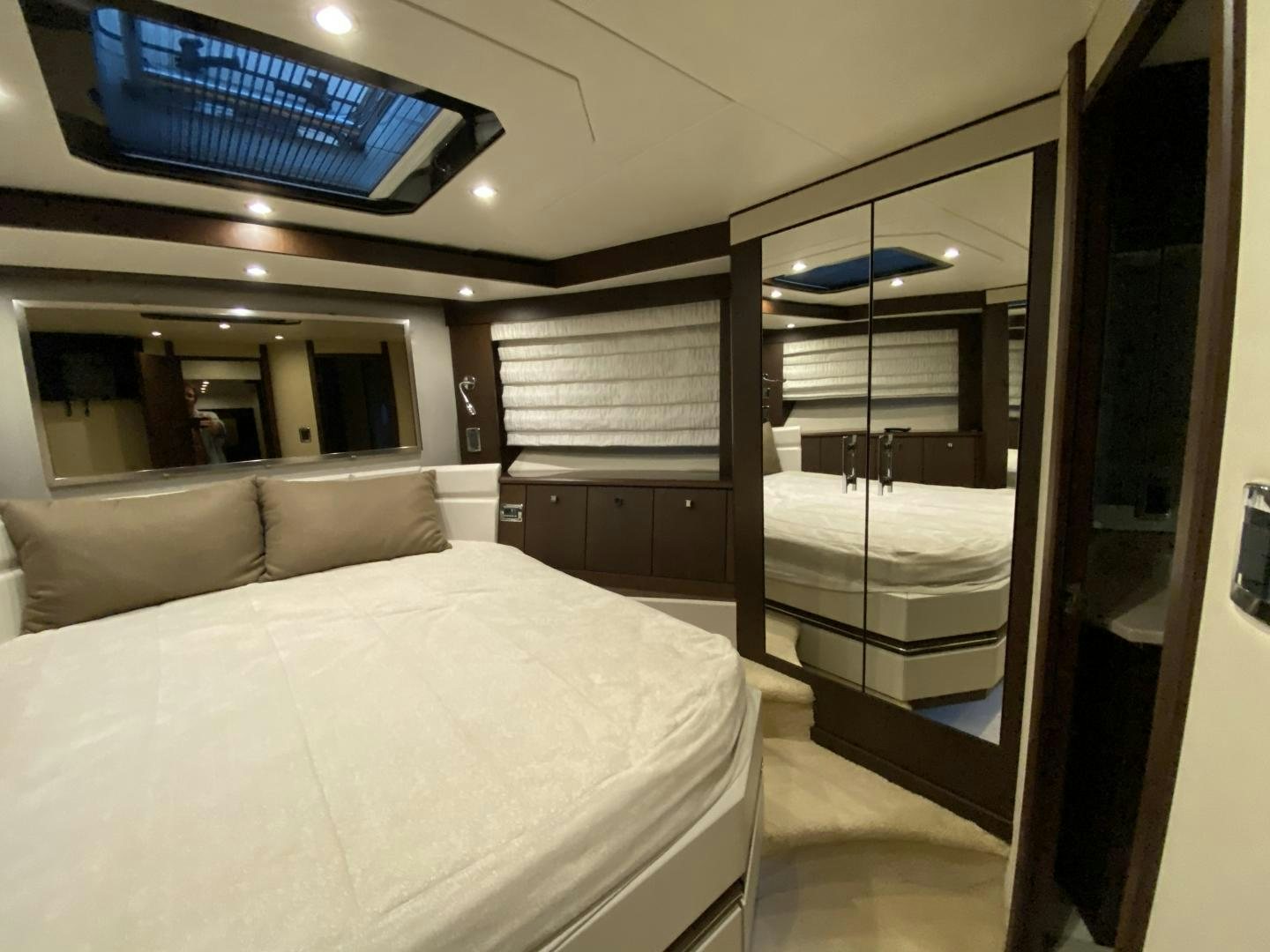 a bedroom with a bed and a couch aboard No Name Yacht for Sale
