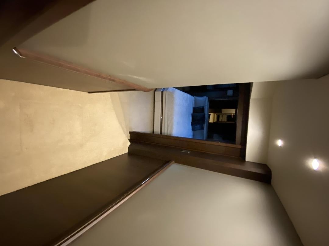 a room with a tv on the wall aboard No Name Yacht for Sale