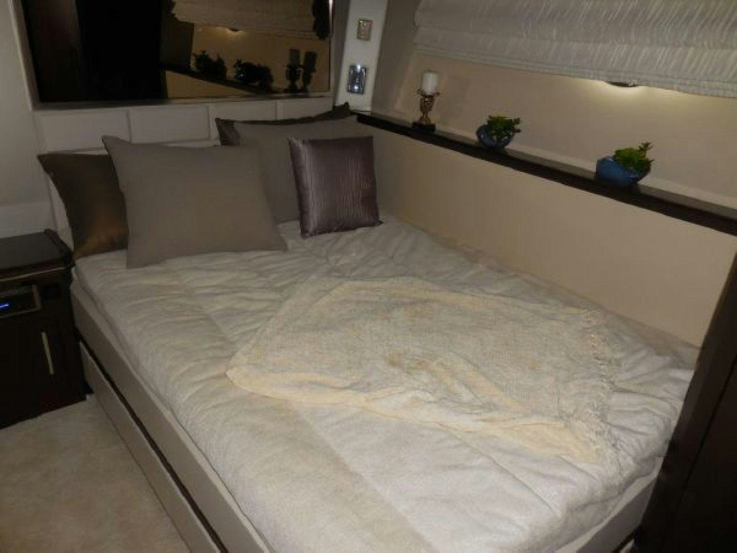 a bed with white sheets aboard No Name Yacht for Sale