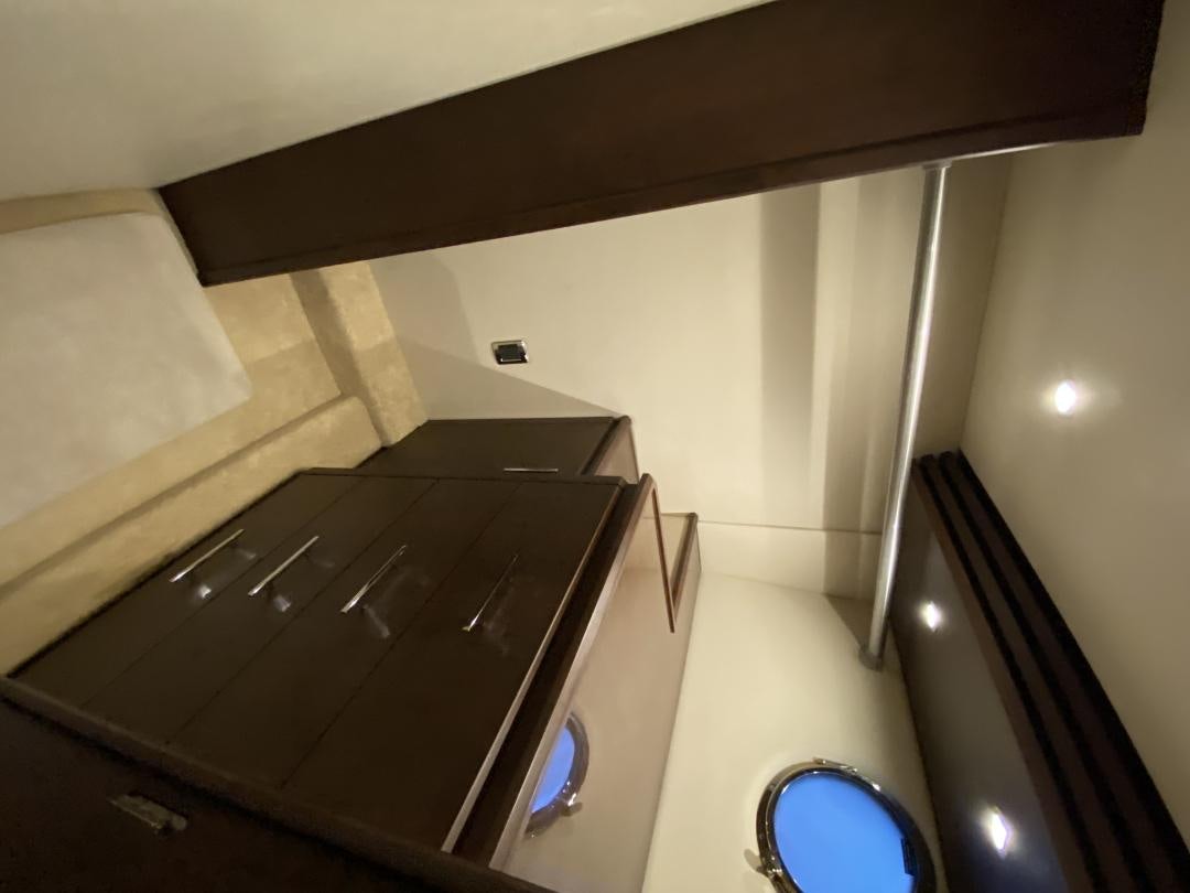 a room with a closet and a shelf with a mirror aboard No Name Yacht for Sale