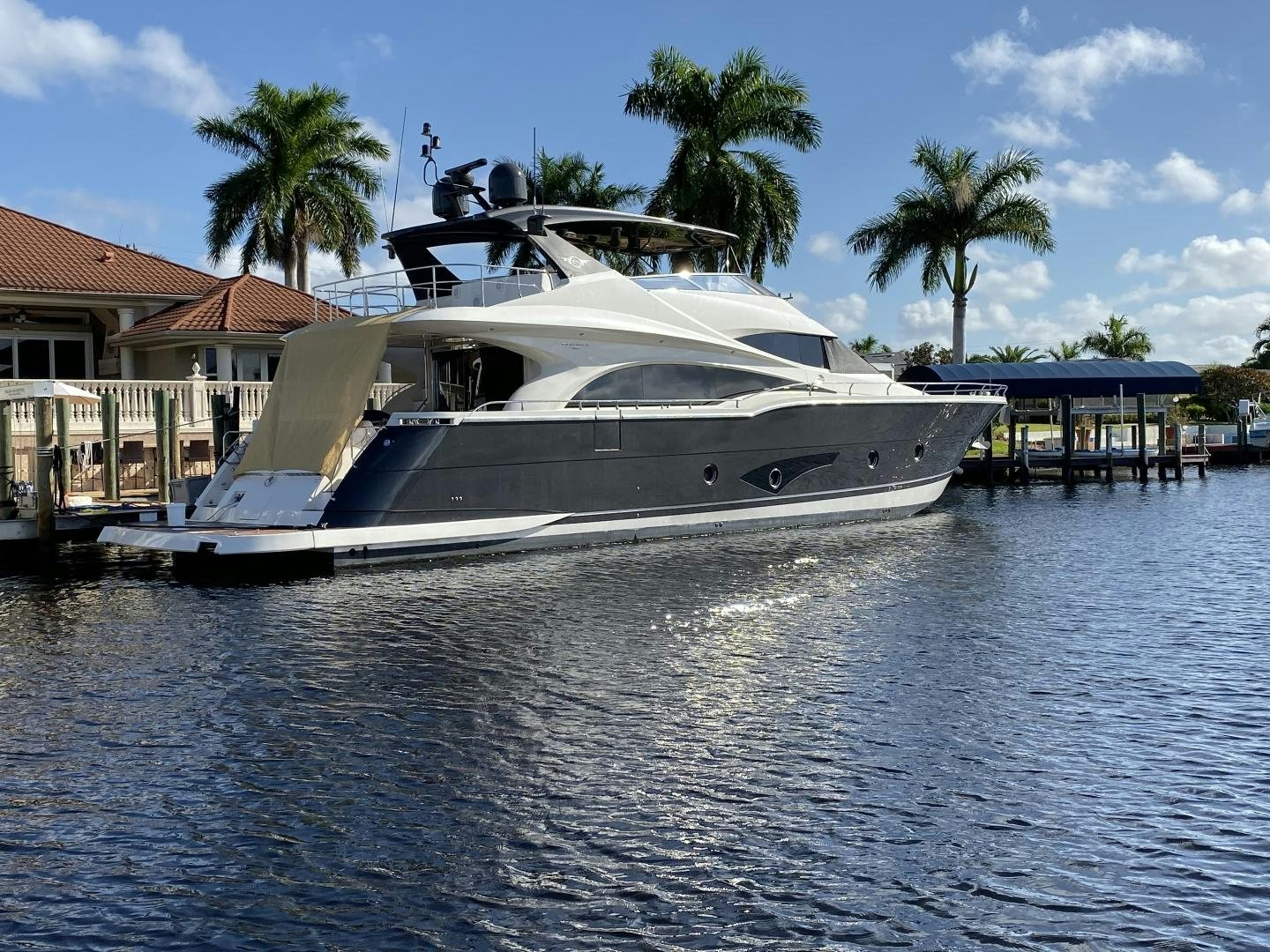 a white yacht docked at a pier aboard No Name Yacht for Sale