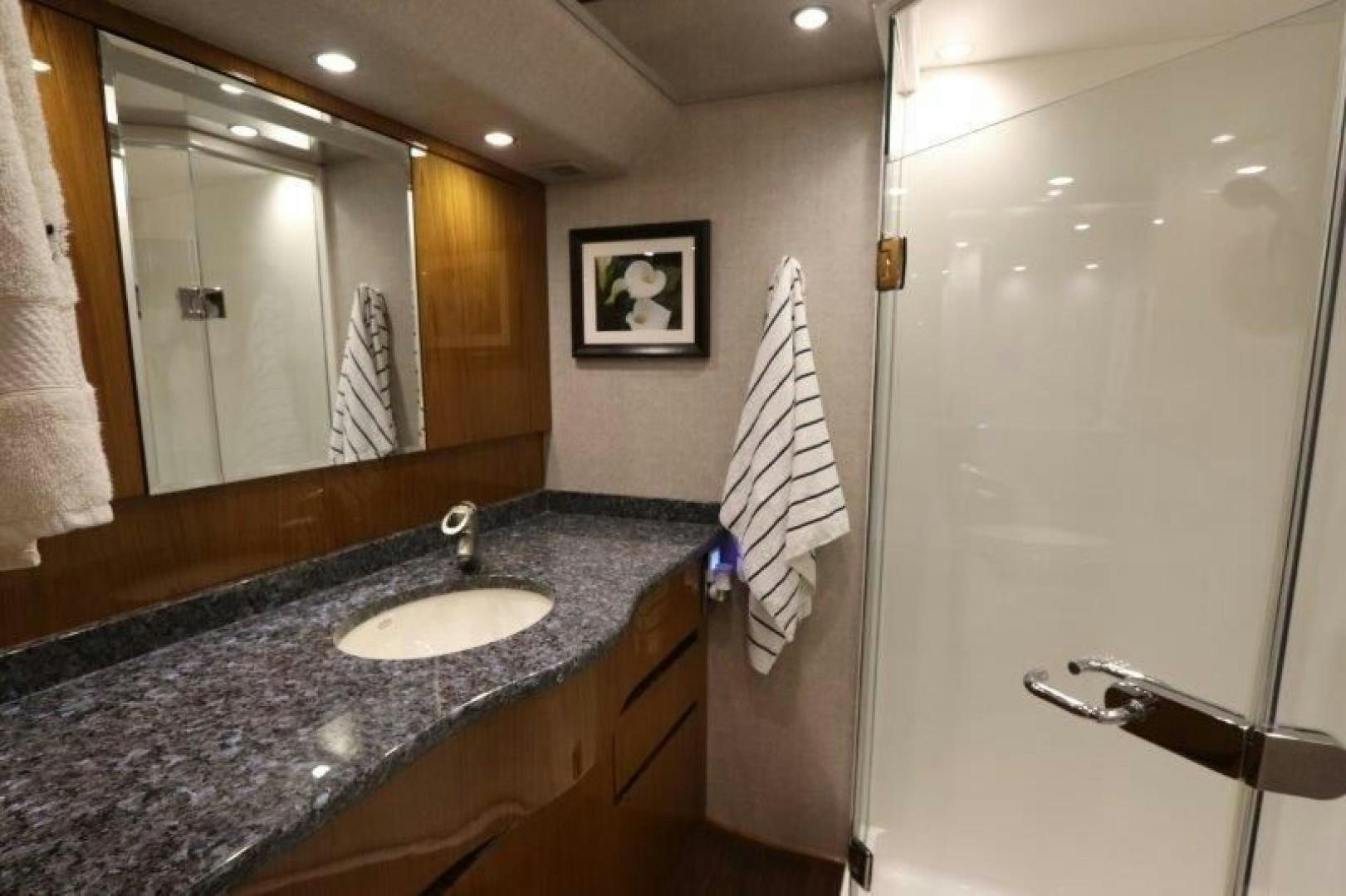 a bathroom with a marble countertop aboard No Name Yacht for Sale