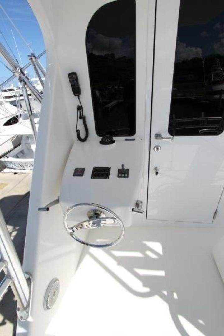 a white vehicle with a round mirror aboard No Name Yacht for Sale
