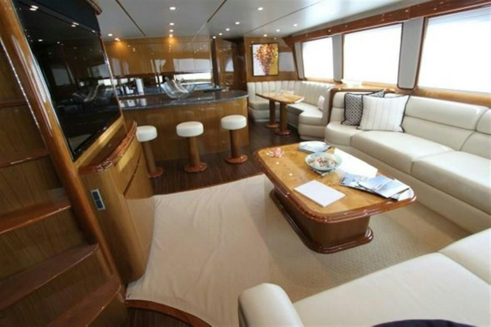 a living room with a couch and a table aboard No Name Yacht for Sale