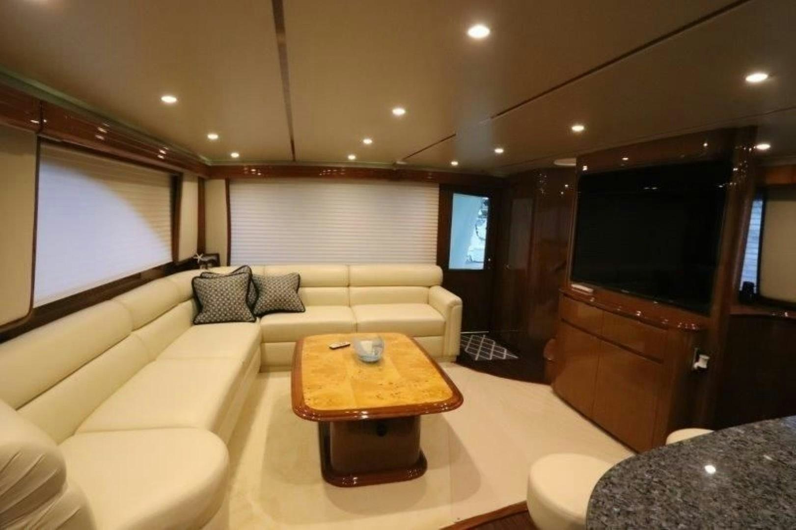 a living room with a couch and a television aboard No Name Yacht for Sale