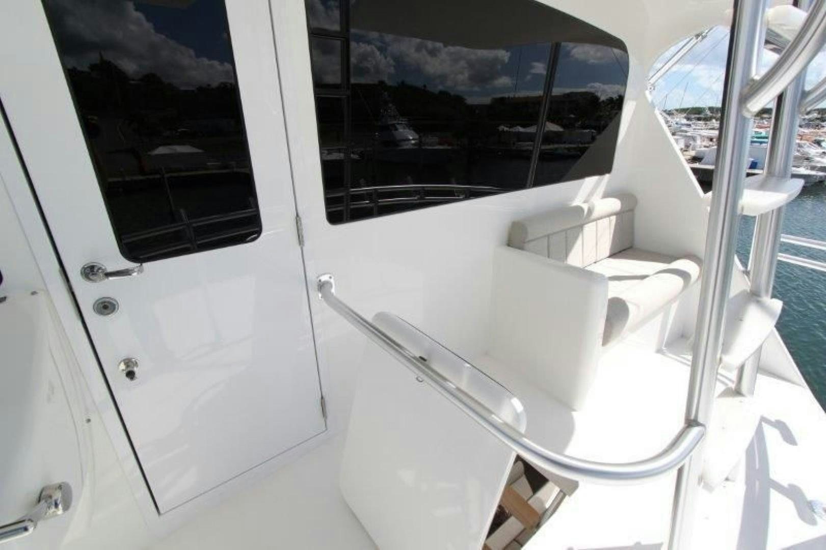 a white boat with a window aboard No Name Yacht for Sale