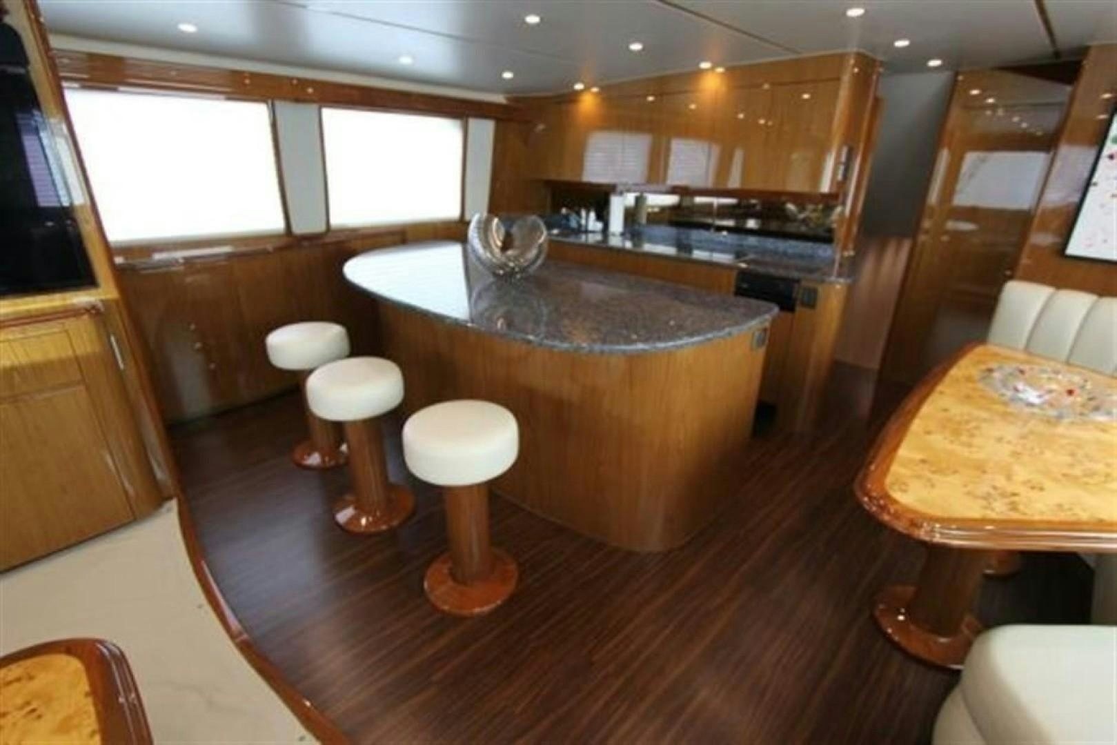 a kitchen with a bar and stools aboard No Name Yacht for Sale