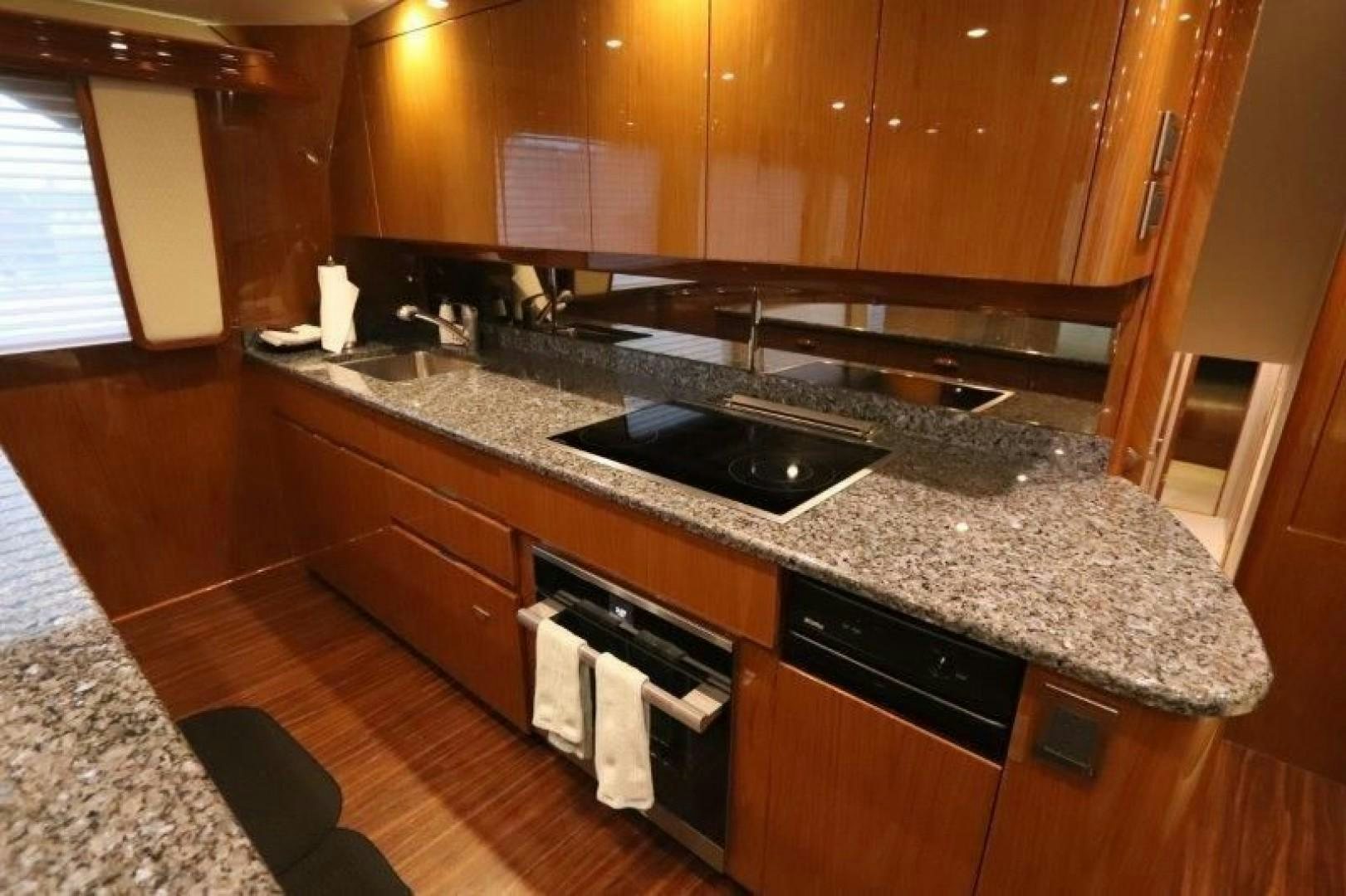 a kitchen with a black stove aboard No Name Yacht for Sale