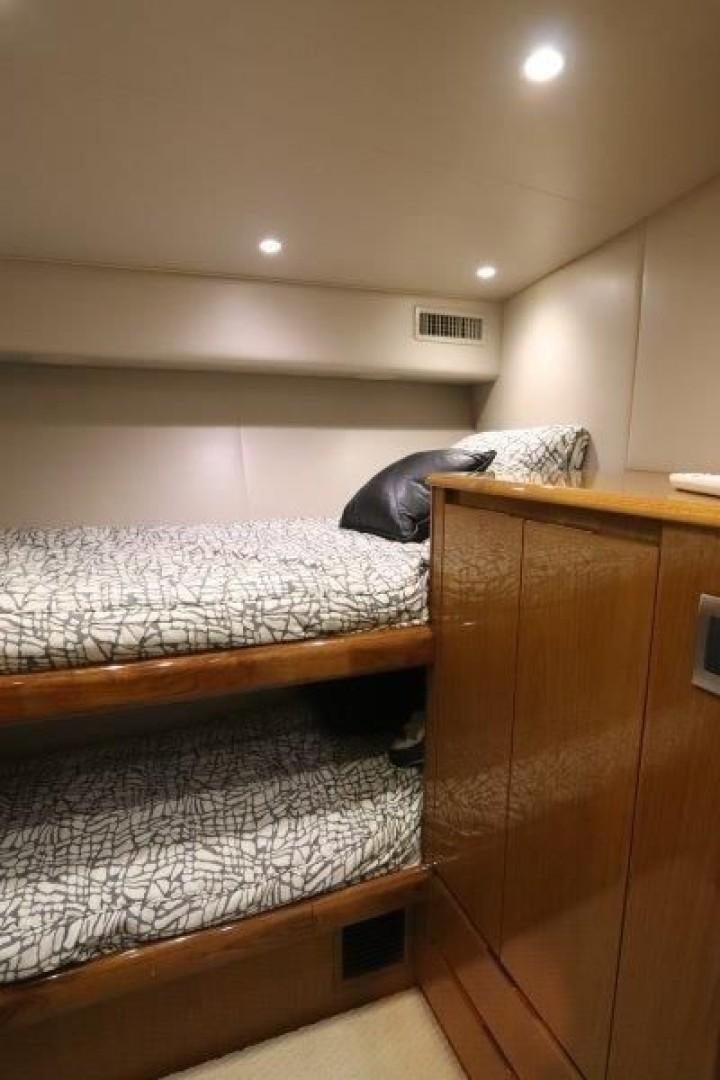 a bed with a white bed spread aboard No Name Yacht for Sale