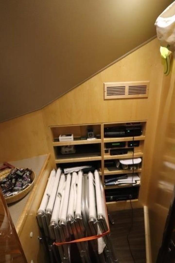 a closet with clothes and a shelf aboard No Name Yacht for Sale