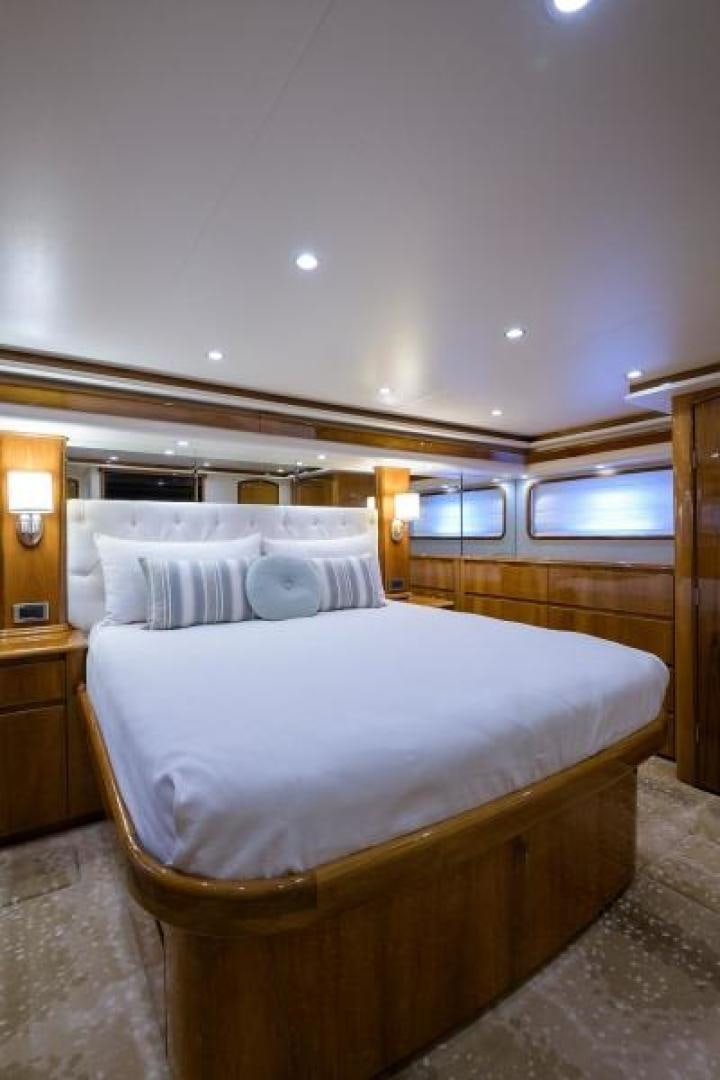 a bed with a white comforter aboard OSH IT Yacht for Sale