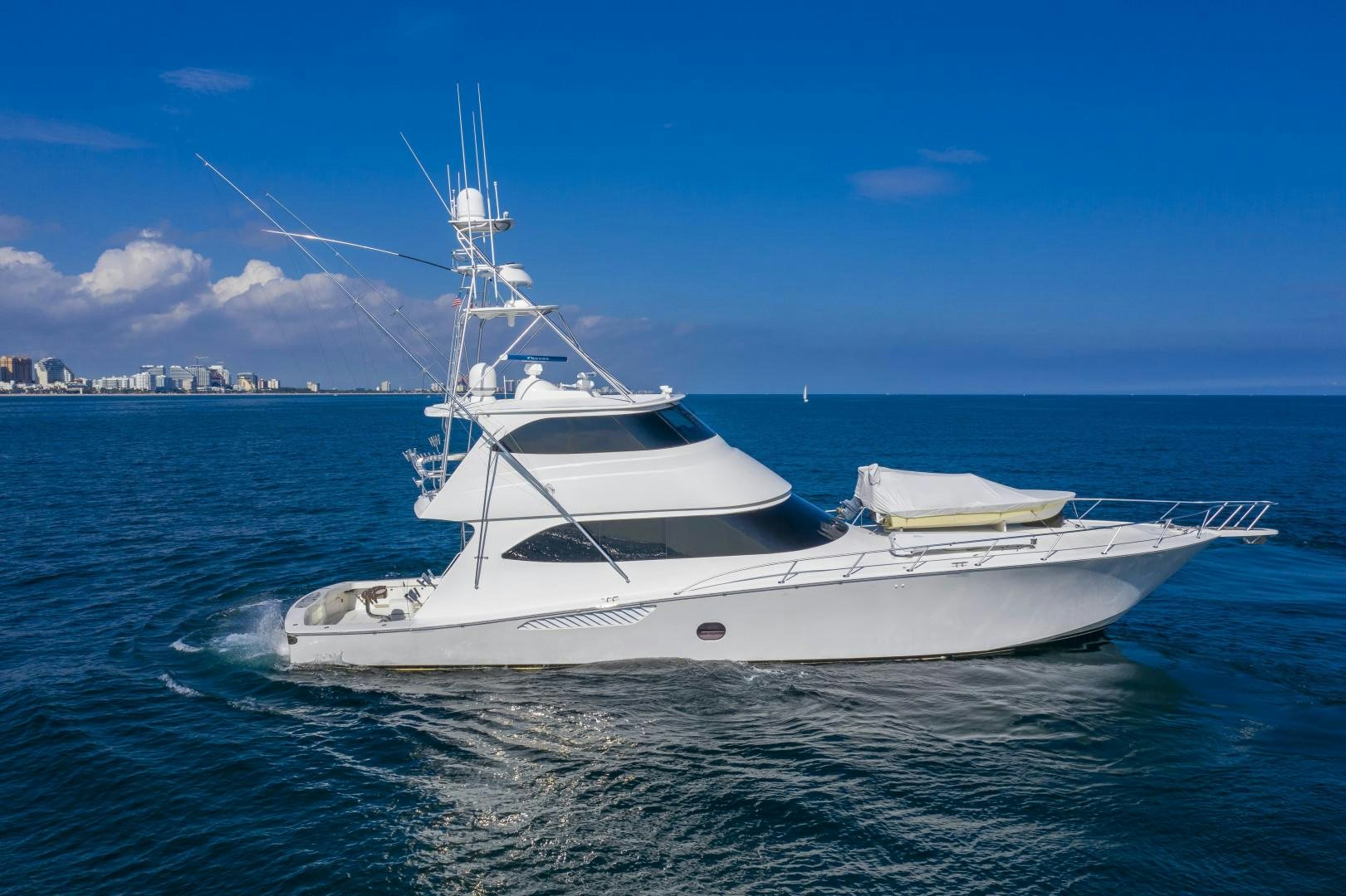 a white boat on the water aboard OSH IT Yacht for Sale