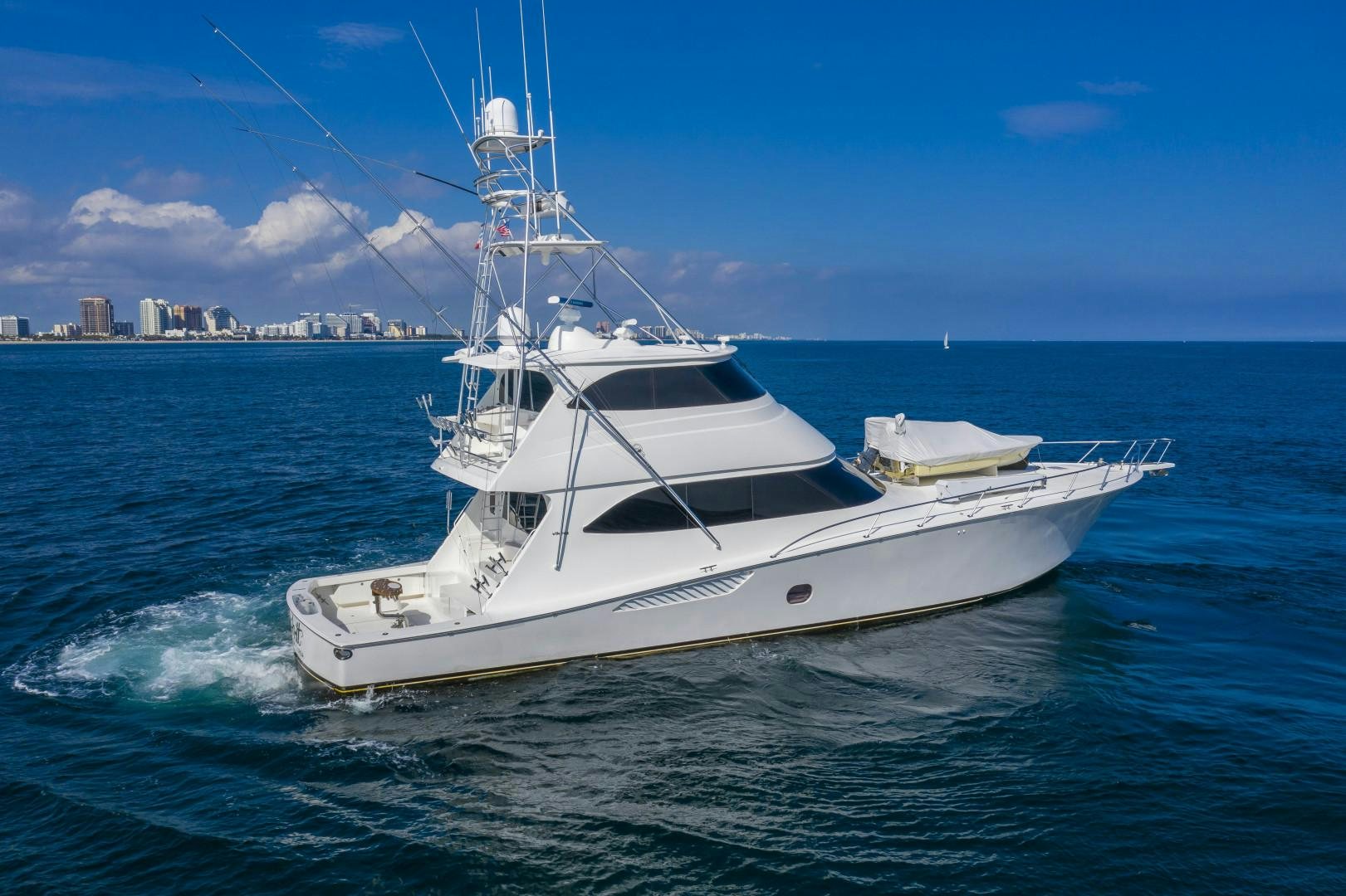 a white yacht in the water aboard OSH IT Yacht for Sale
