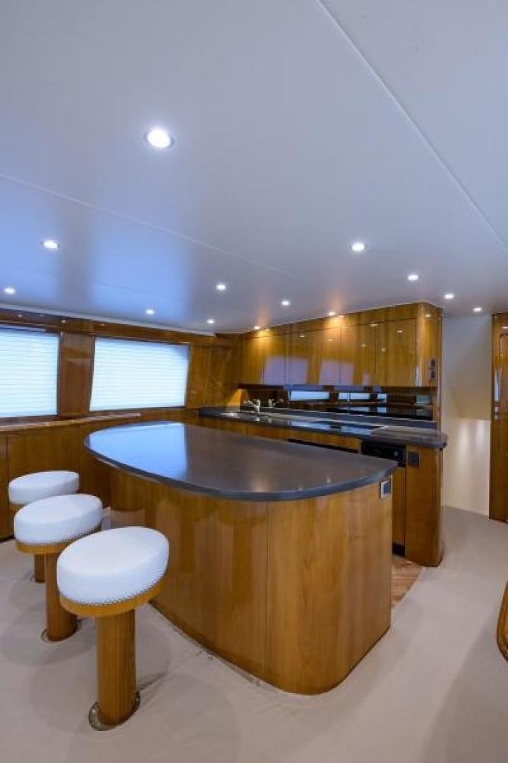 a kitchen with a bar and stools aboard OSH IT Yacht for Sale