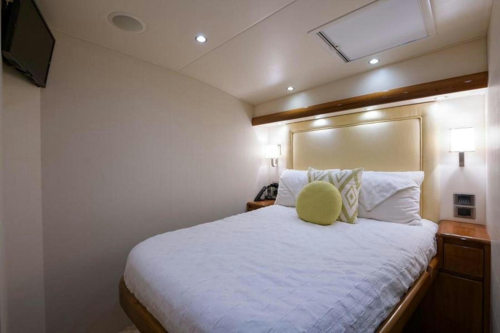 a bed with a white comforter aboard OSH IT Yacht for Sale