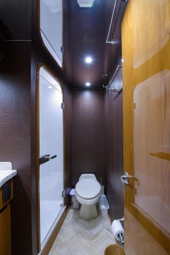 a bathroom with a toilet and a mirror aboard OSH IT Yacht for Sale