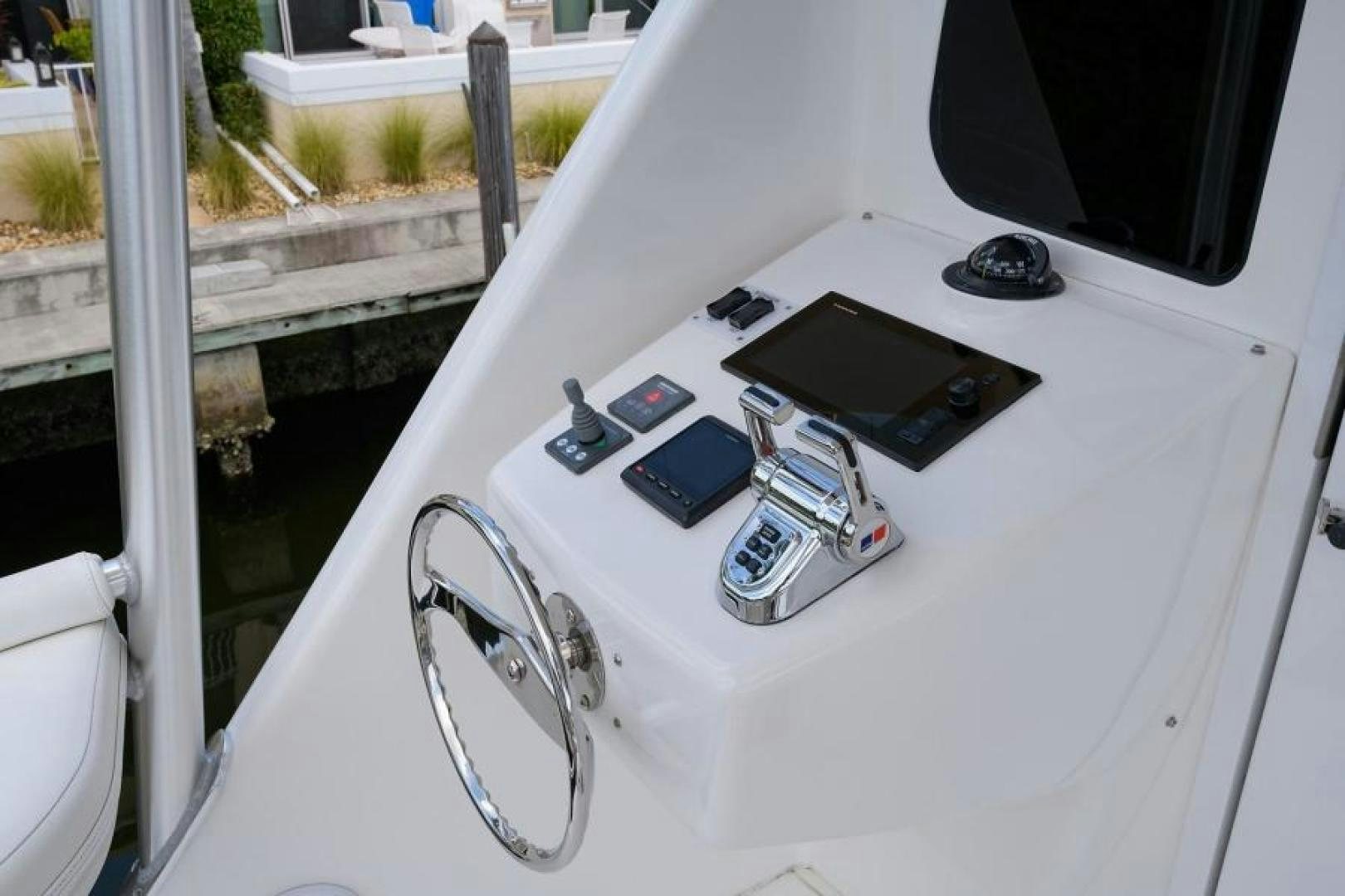 a group of electronic devices on a car hood aboard OSH IT Yacht for Sale