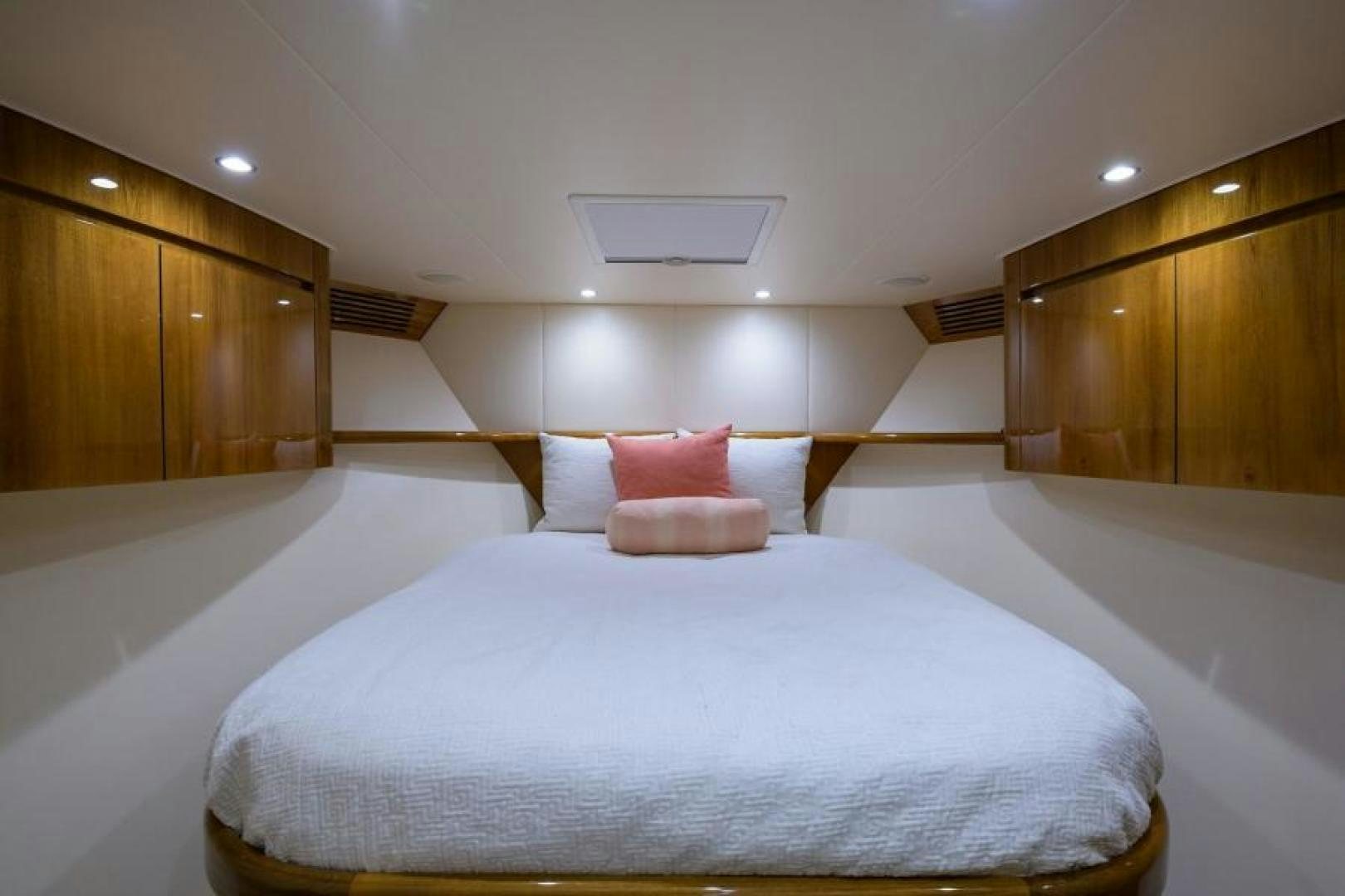 a bed with pink pillows aboard OSH IT Yacht for Sale