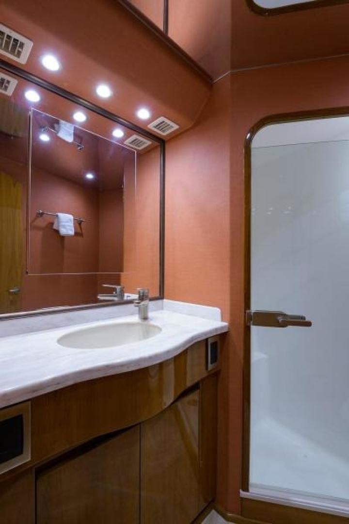 a bathroom with a large mirror aboard OSH IT Yacht for Sale