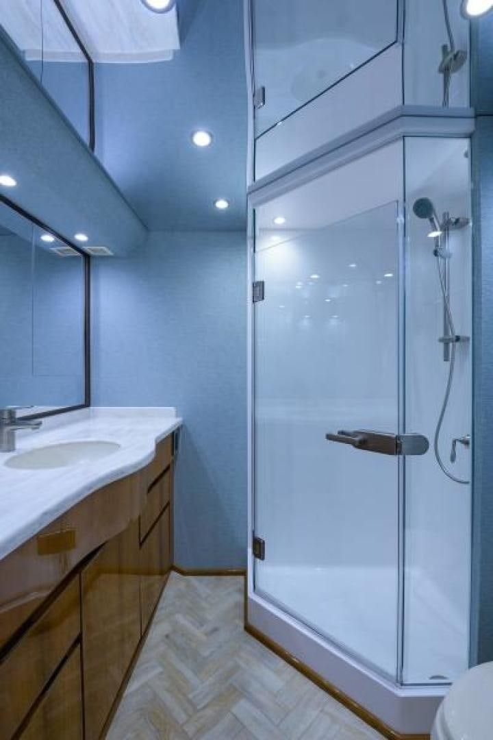 a bathroom with a shower and sink aboard OSH IT Yacht for Sale