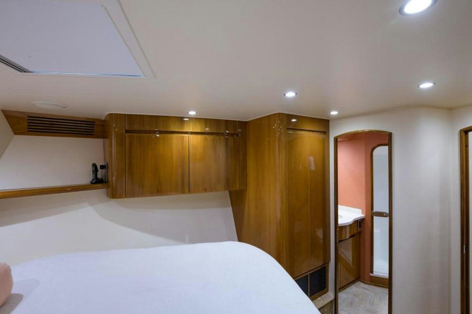 a room with a bed and a mirror aboard OSH IT Yacht for Sale