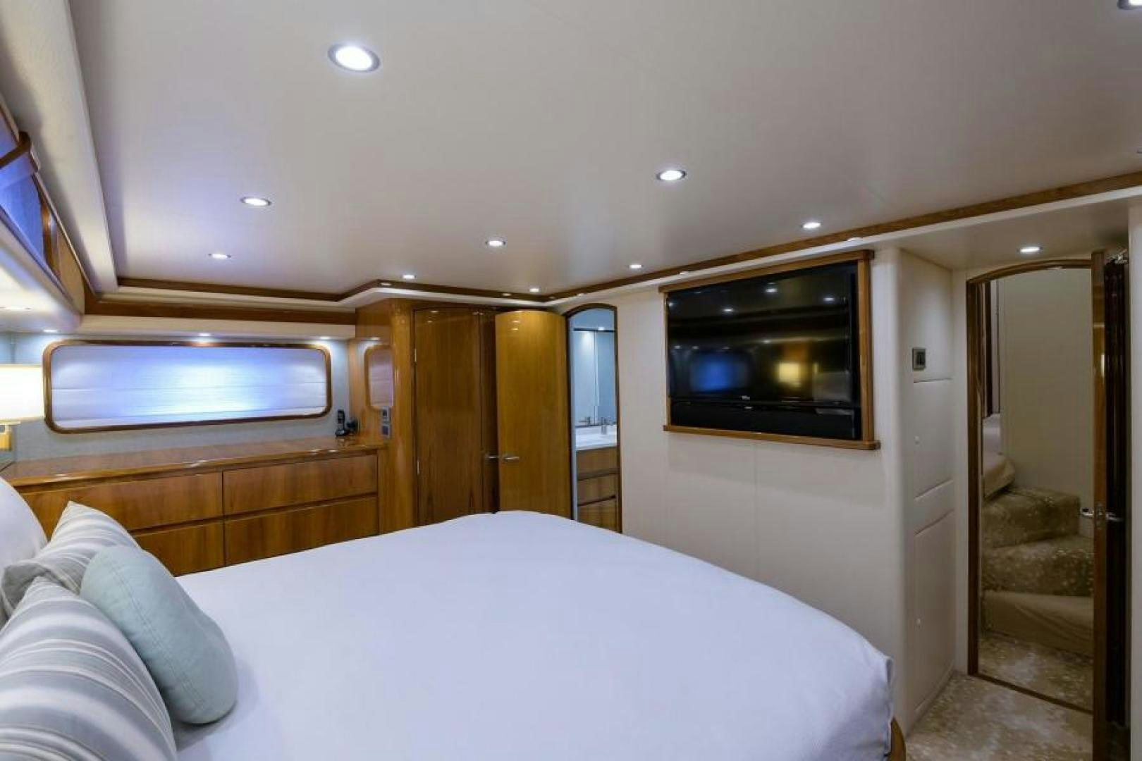 a bedroom with a bed and a television aboard OSH IT Yacht for Sale