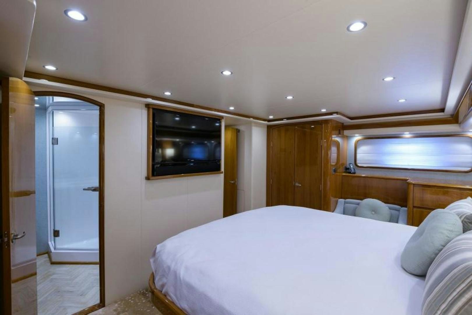 a bedroom with a bed and a television aboard OSH IT Yacht for Sale