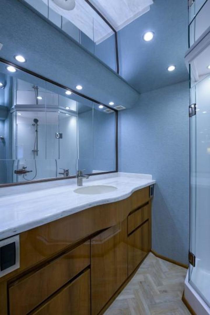 a bathroom with a large mirror aboard OSH IT Yacht for Sale