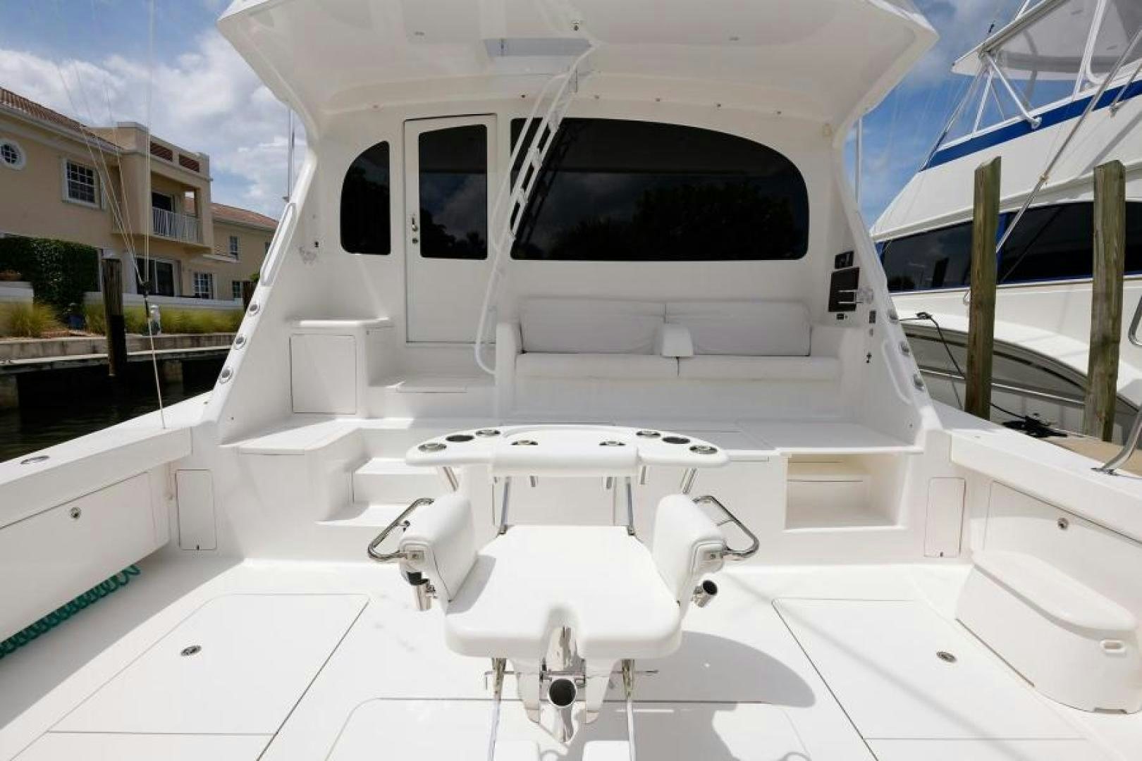 a white car with a door open aboard OSH IT Yacht for Sale