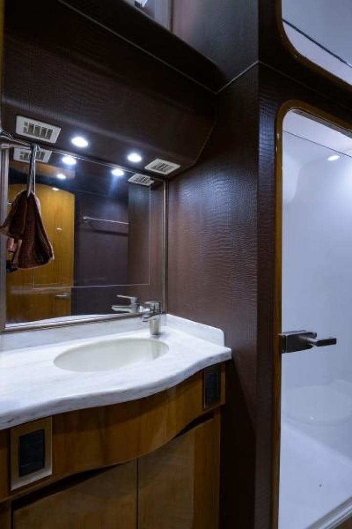 a bathroom with a sink and mirror aboard OSH IT Yacht for Sale