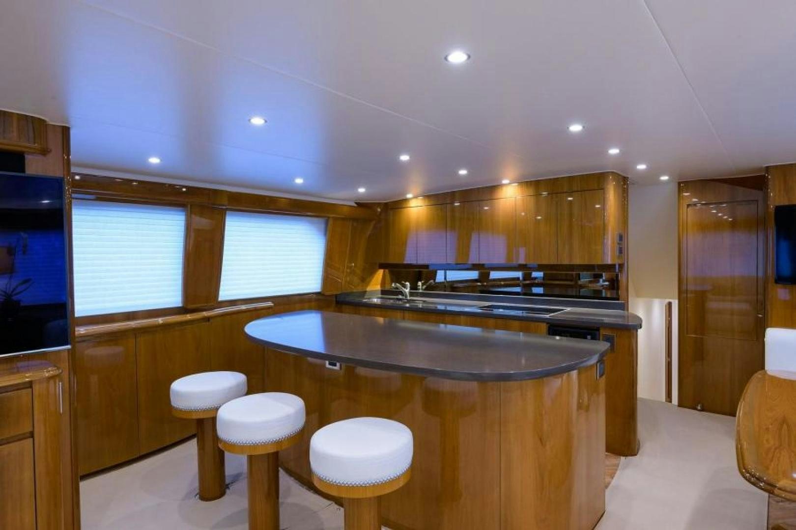 a kitchen with a bar and stools aboard OSH IT Yacht for Sale