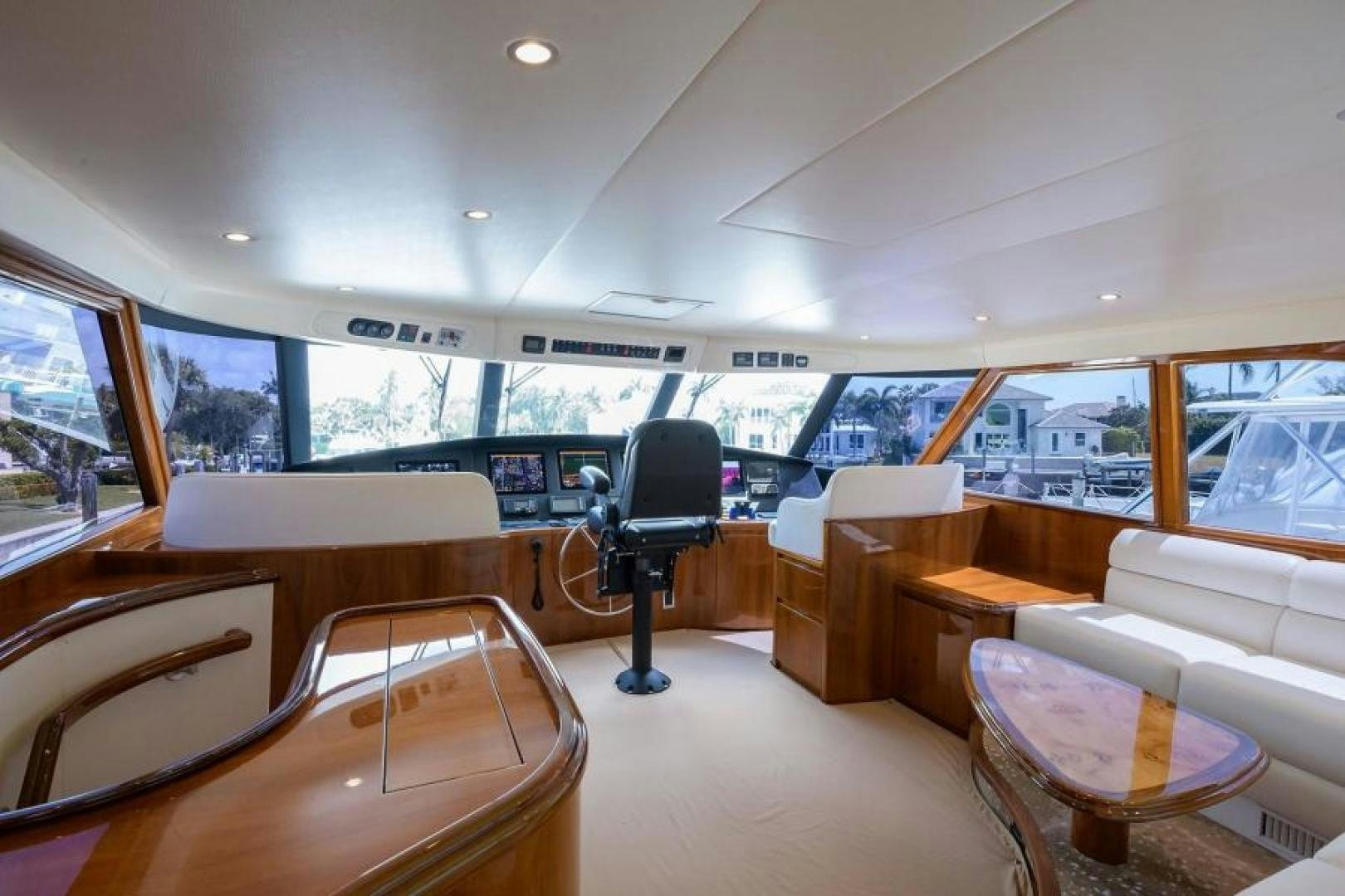 inside of a vehicle with a large window and a table and chairs aboard OSH IT Yacht for Sale