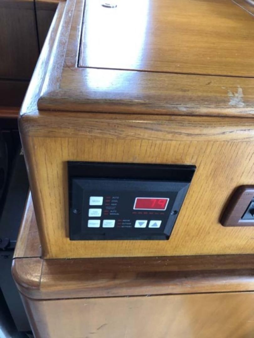 a black rectangular object on a wooden surface aboard PRIME TIME Yacht for Sale