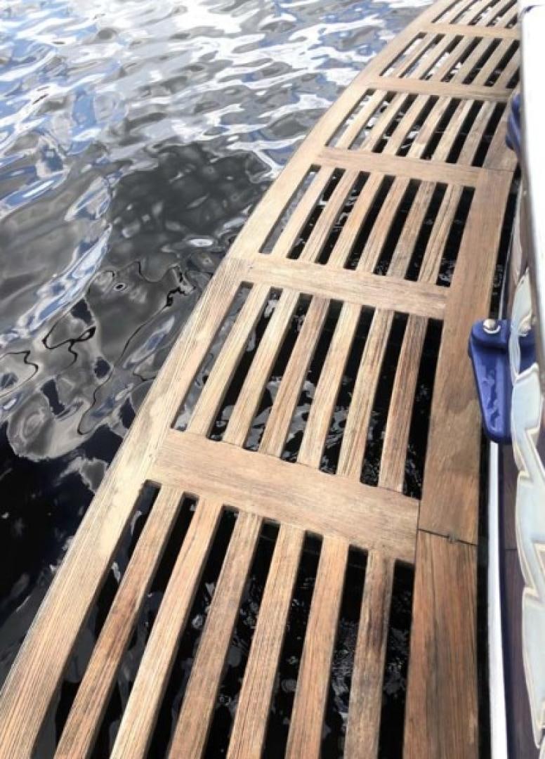 a wooden dock with a chain aboard PRIME TIME Yacht for Sale