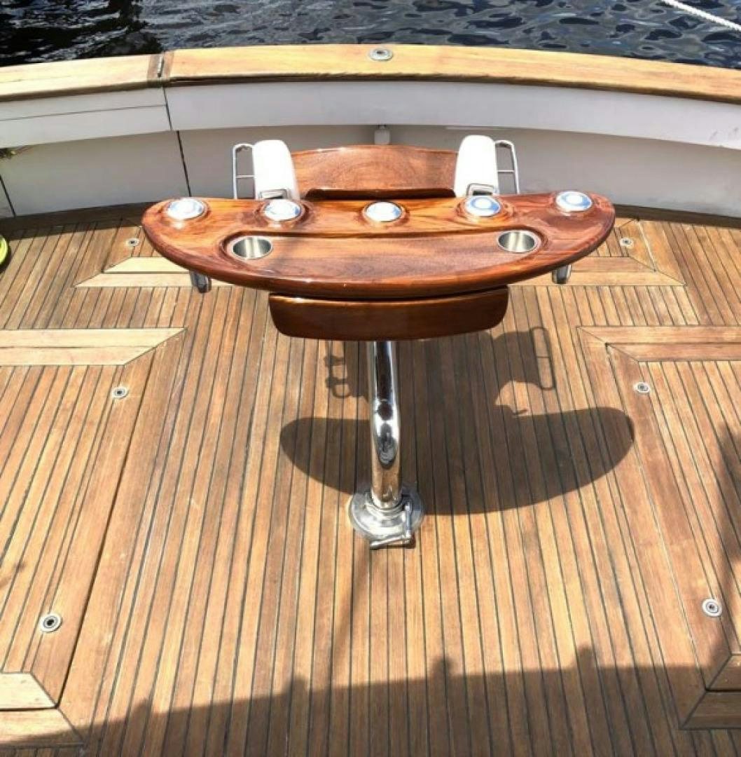 a wooden coffee table aboard PRIME TIME Yacht for Sale