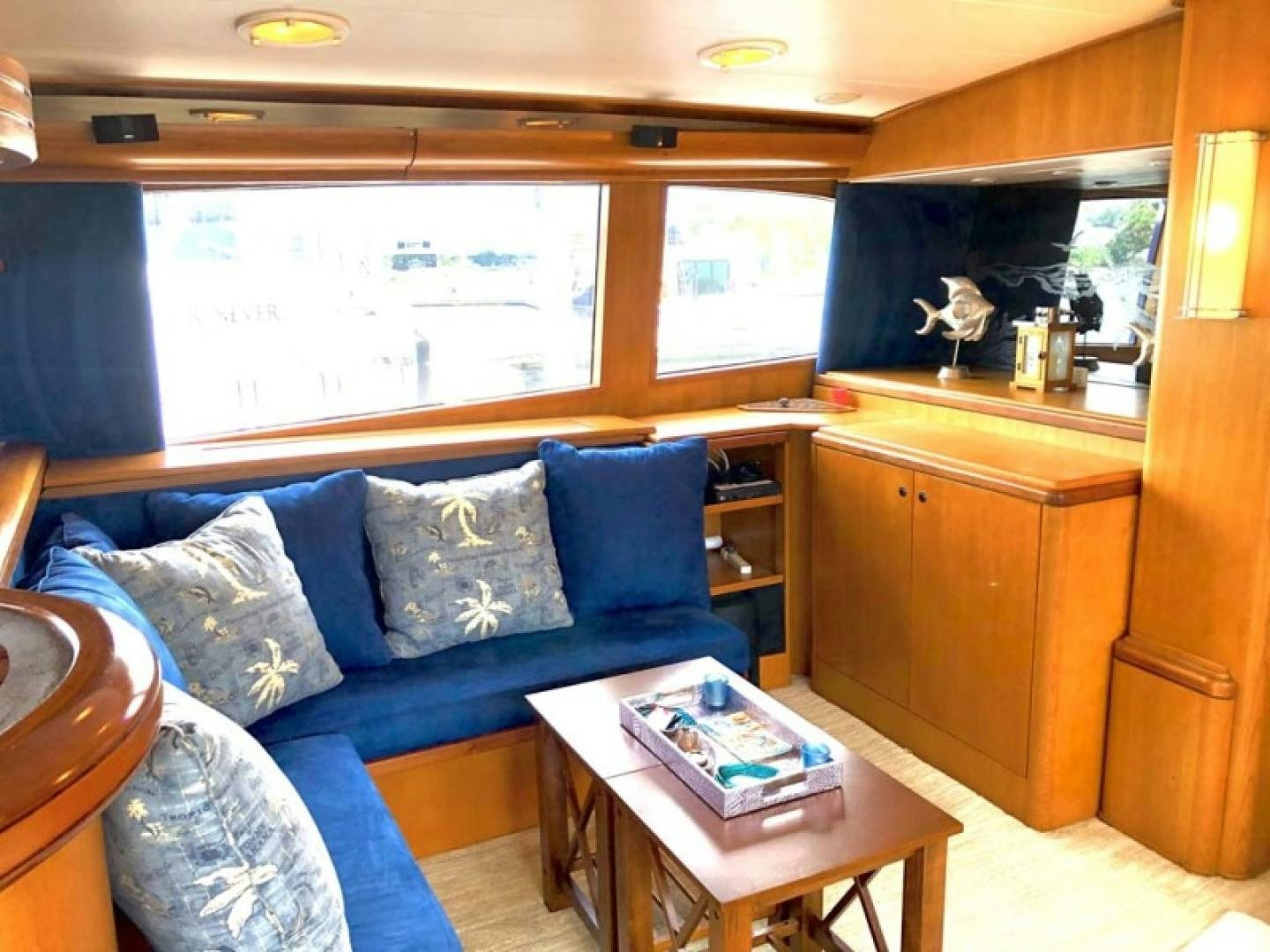 a living room with a couch and a coffee table aboard PRIME TIME Yacht for Sale