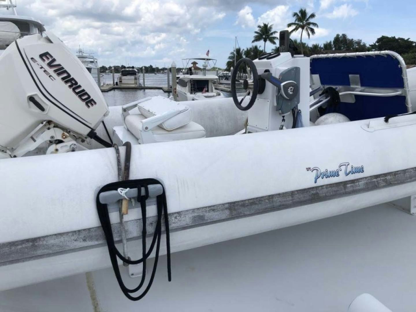 a white boat with a steering wheel aboard PRIME TIME Yacht for Sale