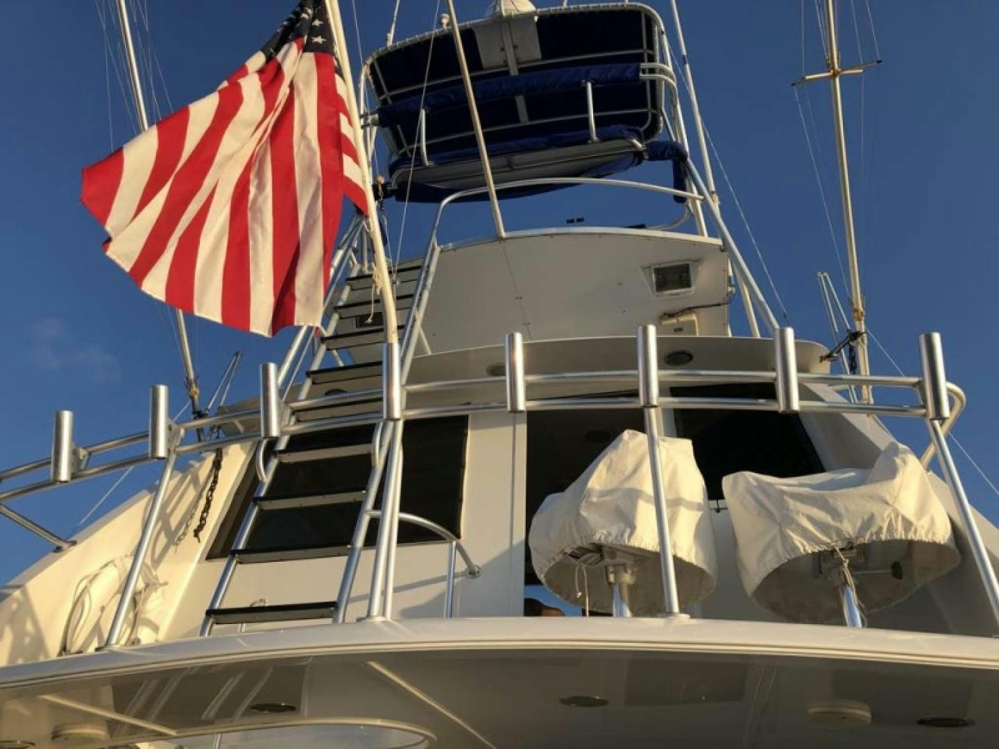 a boat with a flag on the front aboard PRIME TIME Yacht for Sale