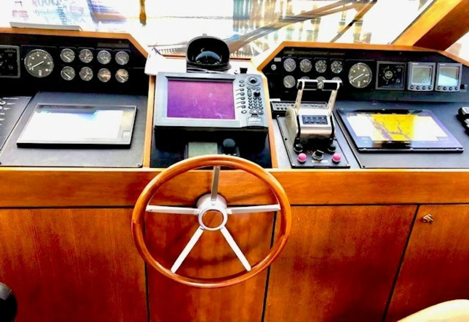 a wooden desk with a telephone and a record player aboard PRIME TIME Yacht for Sale