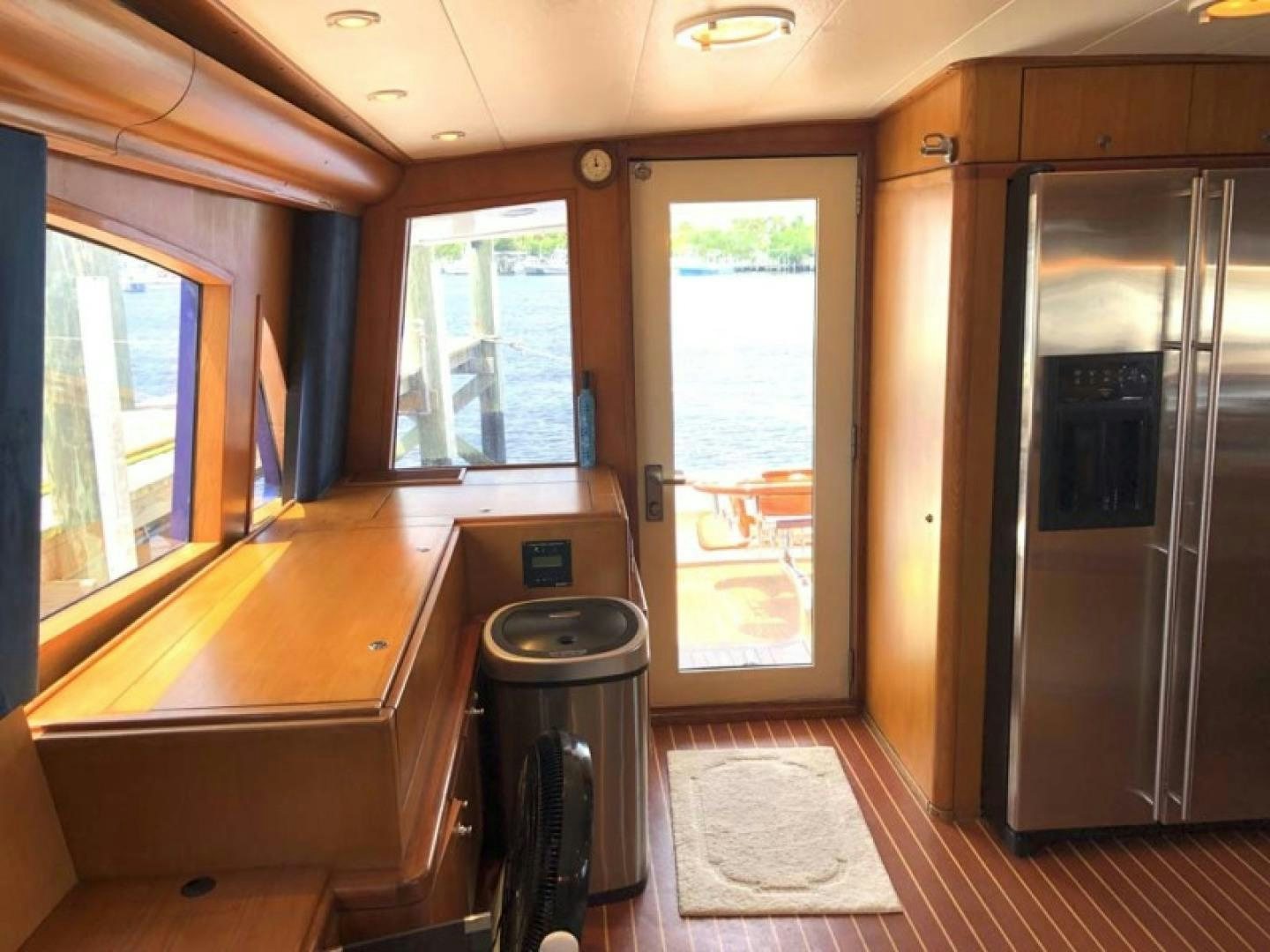 a kitchen with a stainless steel refrigerator aboard PRIME TIME Yacht for Sale