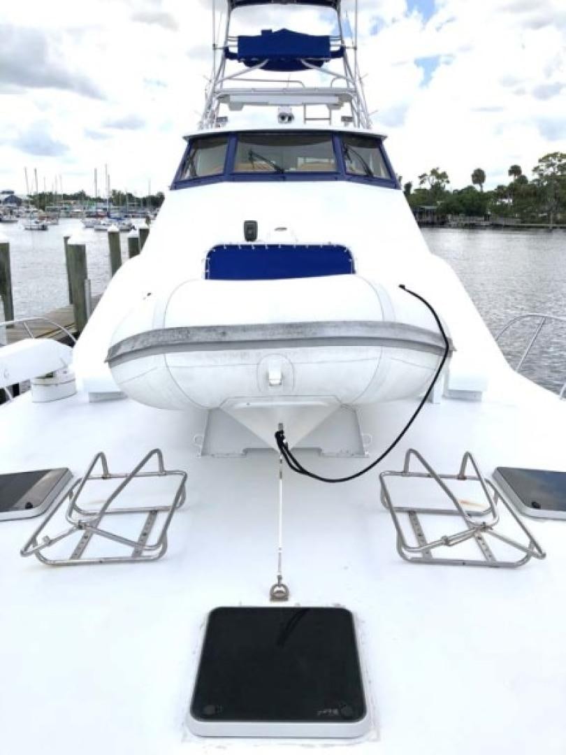 a white yacht docked at a pier aboard PRIME TIME Yacht for Sale