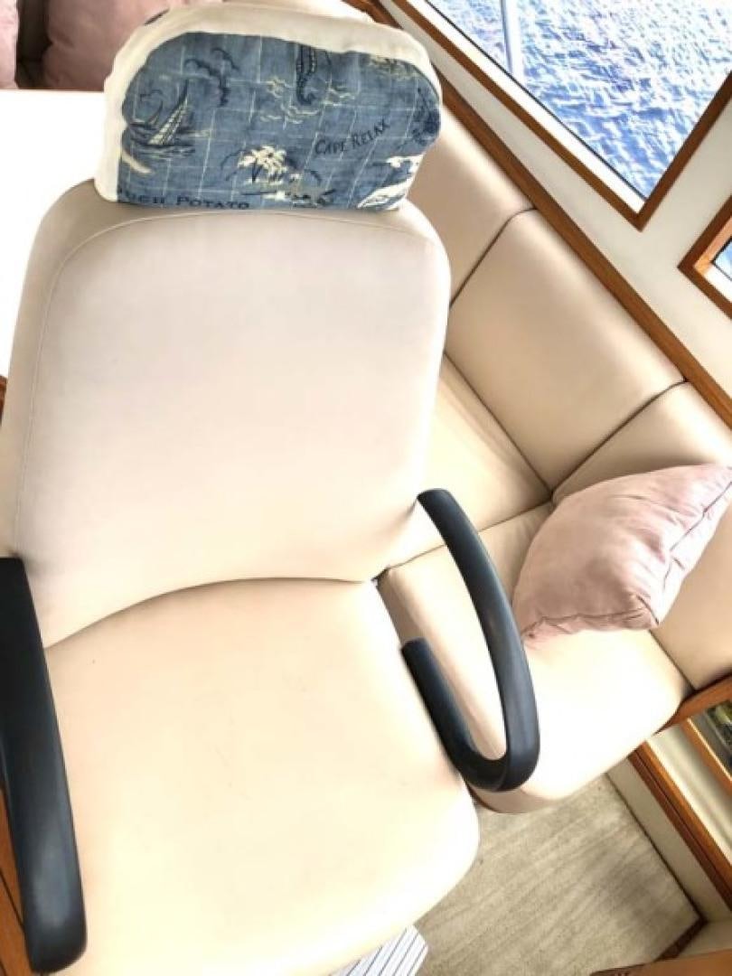 a person's legs and a chair aboard PRIME TIME Yacht for Sale