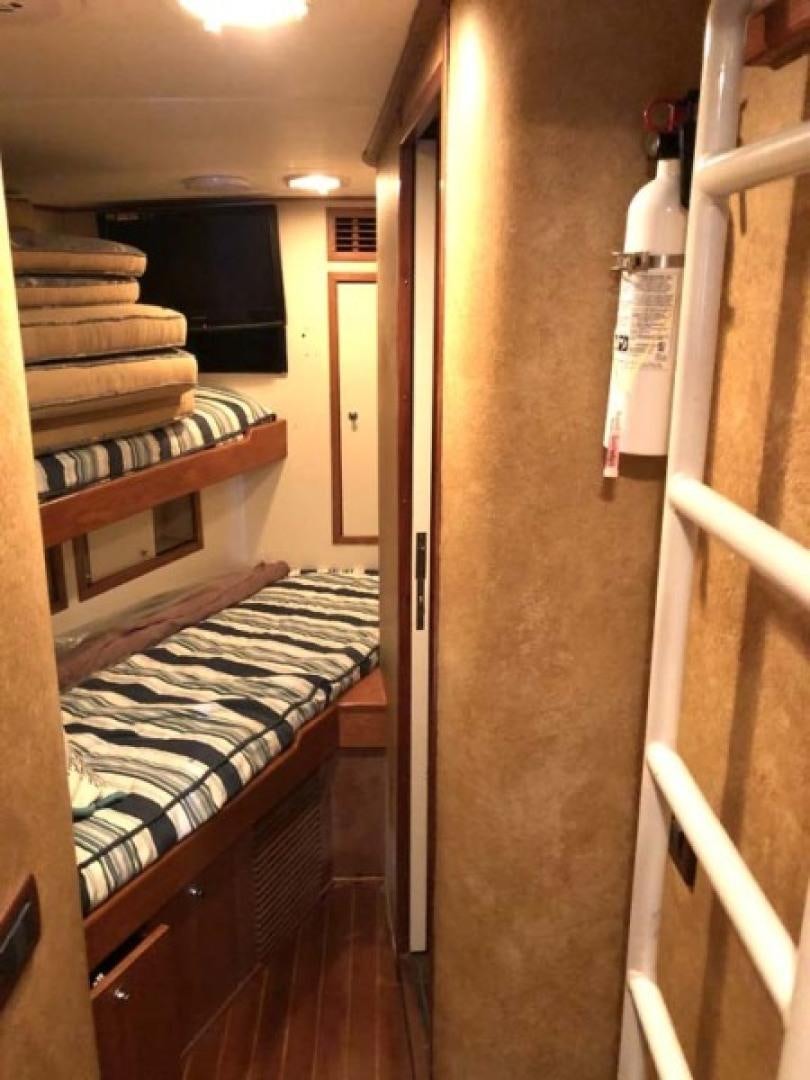 a room with bunk beds aboard PRIME TIME Yacht for Sale