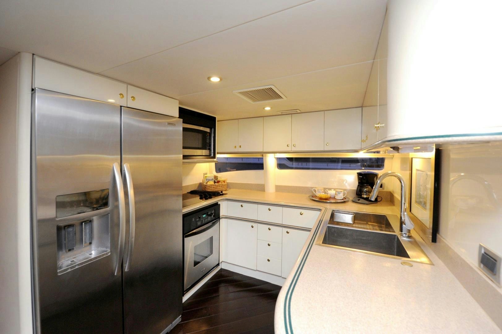 a kitchen with stainless steel appliances aboard PLAN B Yacht for Sale