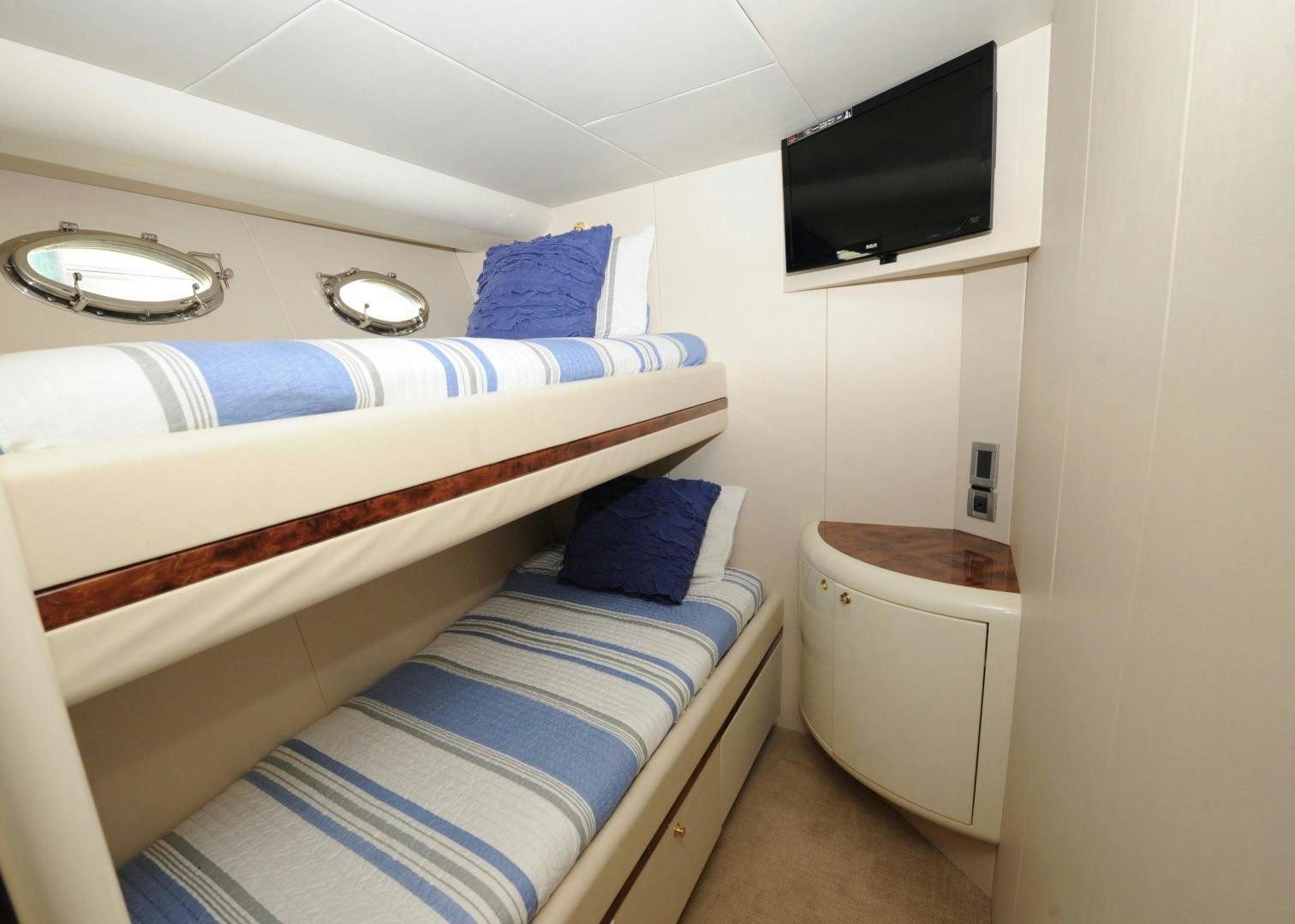a room with a bed and a television aboard PLAN B Yacht for Sale