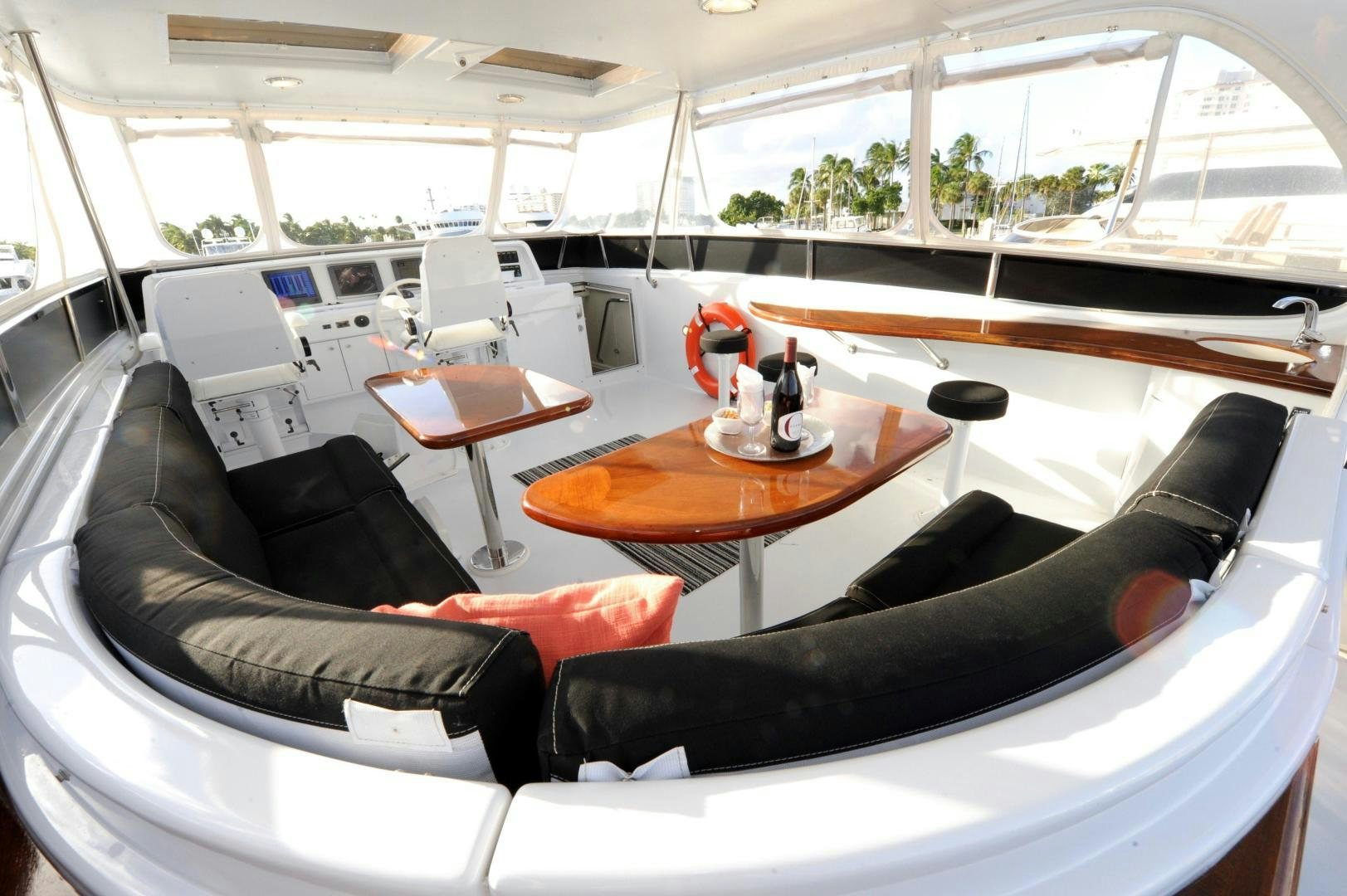 a room with a couch and a table and chairs aboard PLAN B Yacht for Sale
