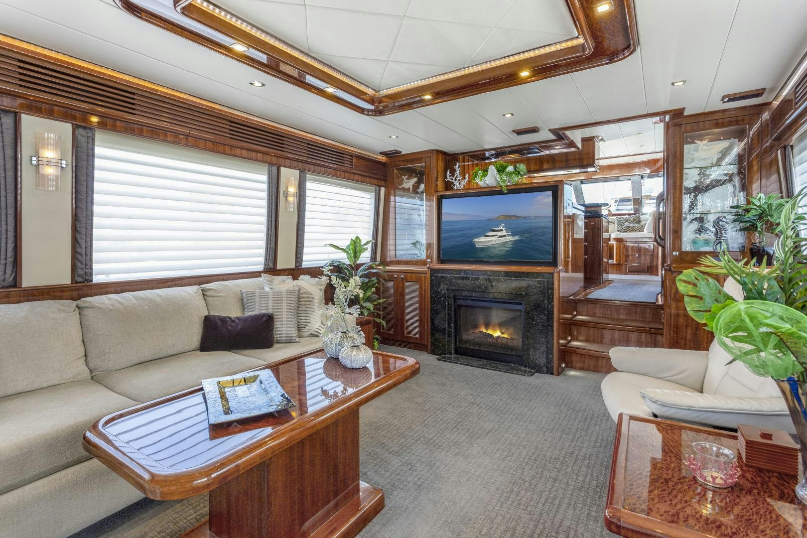 a living room with a fireplace aboard ODYSEA Yacht for Sale