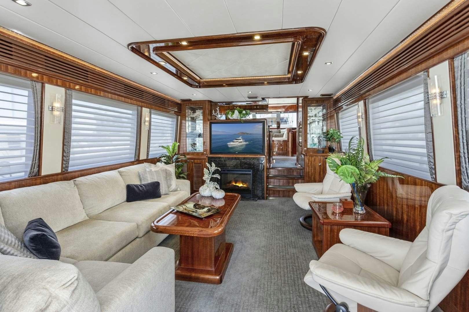 a living room with a fireplace aboard ODYSEA Yacht for Sale